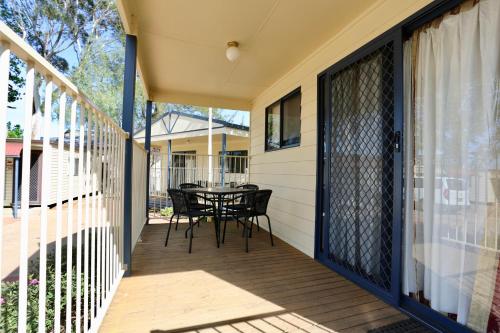 a screened porch with a table and chairs on it at Young Caravan and Tourist Park in Young