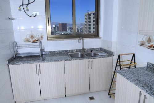 a kitchen with a sink and a window at My dream apartment in Addis Ababa