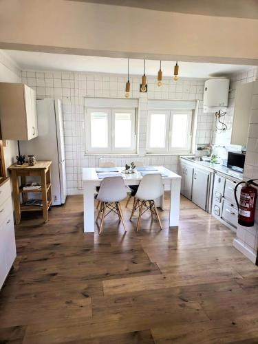a kitchen with a white table and two chairs at Apartamento rural in Pravia