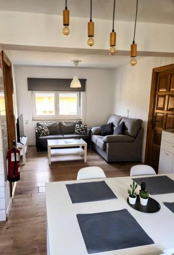 a living room with a couch and a table at Apartamento rural in Pravia