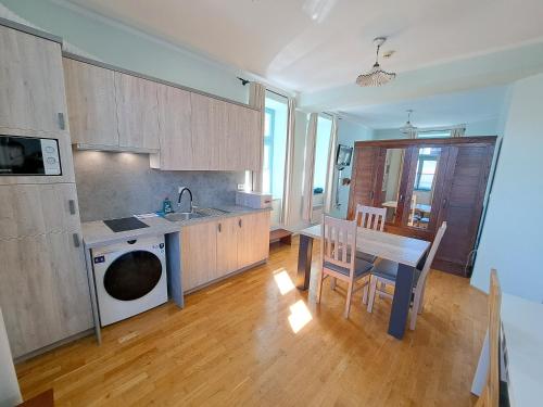 a kitchen and dining room with a table and a dishwasher at Villa Parma in Maribor Self check - in in Maribor
