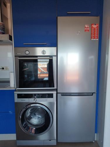 a refrigerator and a washing machine in a kitchen at Cambados Apartamento VUT-PO-TU986D in Cambados