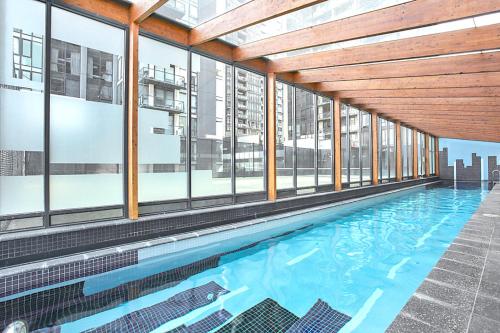an indoor swimming pool in a building with windows at Ultimate Southbank Getaway with Free Parking in Melbourne