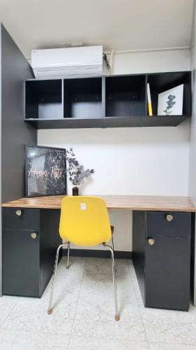 a yellow chair sitting in front of a desk at Petit Mejong in Seoul
