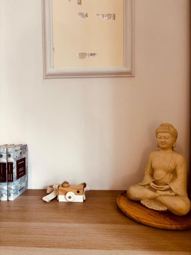 a buddha statue sitting on the floor in a room at Iviskos Living Spot IΙ in Kavala