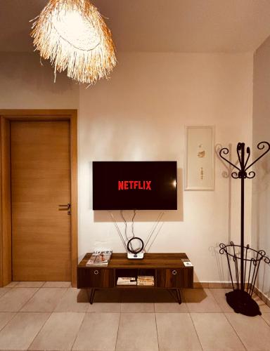 a living room with a tv and a coffee table at Iviskos Living Spot IΙ in Kavala