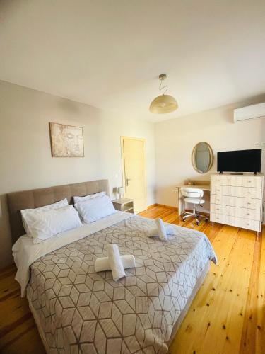 a bedroom with a large bed with two towels on it at Emily's Apartment in Sparti