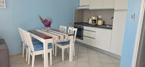 a small kitchen with a table with chairs and a tableablish at Ocean Breeze I in Sal Rei