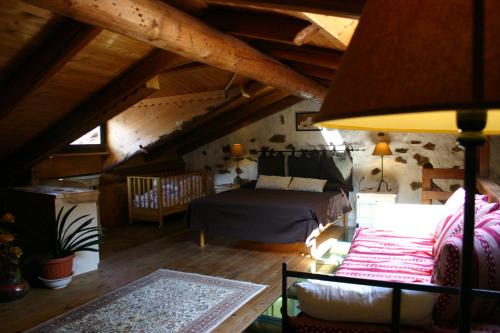 a attic room with a bed and a bedroom at Casa del Vasaio in Tenno