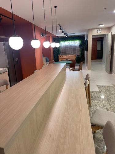 a bar in an office with wooden tables and chairs at Refúgio carioca com piscina in Rio de Janeiro