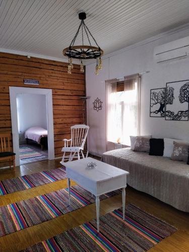 a living room with a bed and a coffee table at Kosken Helmi in Kaustinen