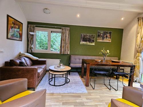 a living room with a couch and a table at Veluwe Flow in Epe