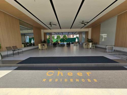 a lobby with a cheese reference sign on the floor at Andele's Place in Marilao