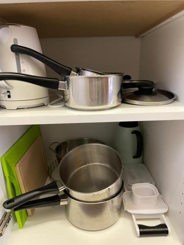 a kitchen shelf with pots and pans and a mixer at Haus Stadel Wohnung Nr. 36 in Albinen