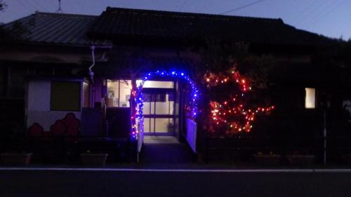 a house with christmas lights on the front of it at Minshuku Mariko / Vacation STAY 895 in Mochimune