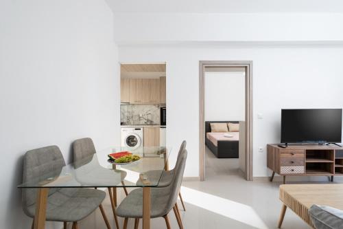 a living room with a glass table and chairs at Brand New House Sitia in Sitia