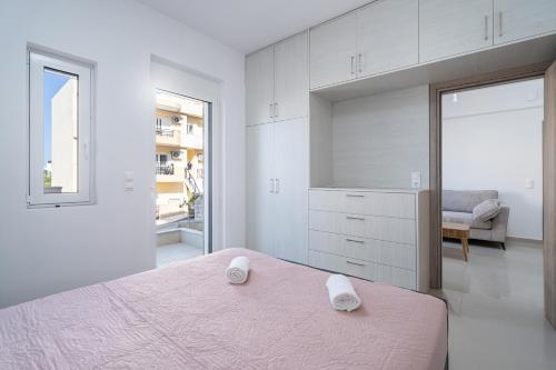a bedroom with a pink bed and a large mirror at Brand New House Sitia in Sitia