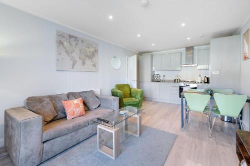 a living room with a couch and a table at The Modern Apartments - 2 Bedroom with Parking by 360Stays in High Wycombe