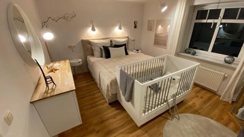 a small bedroom with a white bed and a window at MeerZeit in Langballig