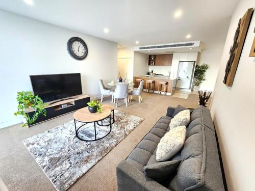 a living room with a couch and a table at Spacious River View Escape with Free Secure Park - 2BR, 2BA and Sofa Bed in Brisbane