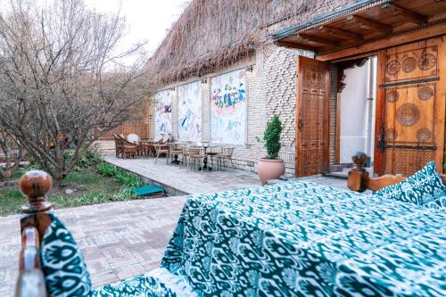 a room with a bed and a patio at Hotel Caravan Serail in Samarkand
