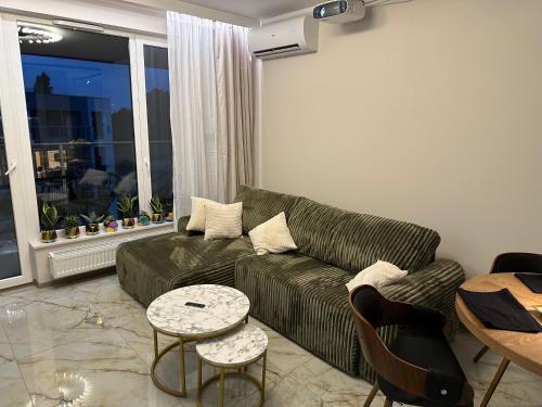 a living room with a couch and a table at Wood & Stone Apartment in Gdańsk