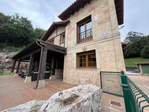 a large stone building with a fence in front of it at Secret Paradise, Stylish Host in Camargo