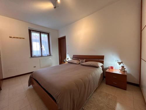 a bedroom with a large bed and a window at Residenza dell'Arco in Gambolò