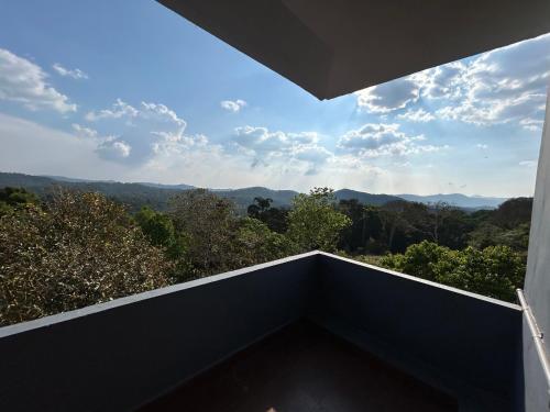 a balcony with a view of the mountains at Mountain View Villas in Madikeri