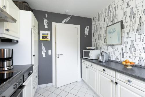Kuchyň nebo kuchyňský kout v ubytování Komfort-Ferienhaus Gröschke Chr-Westphal-Str 17 APPARTO Grömitz