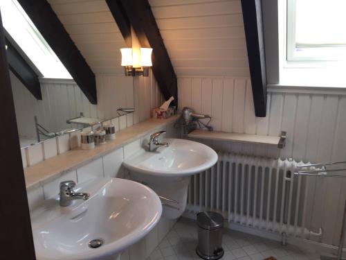 a bathroom with two sinks and a toilet at Ferienhaus im Birkenweg in Worpswede