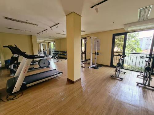 a gym with treadmills and exercise equipment in a building at Casa Josefina in Manila