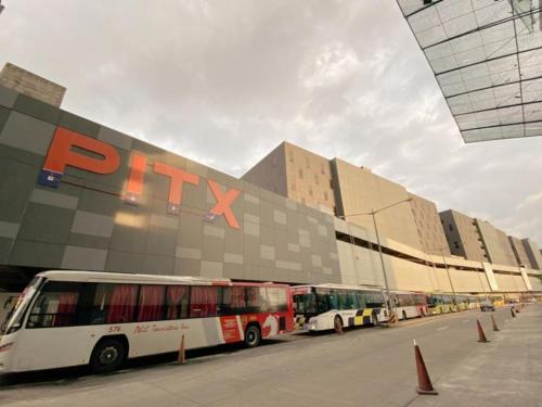 a group of buses parked in front of a building at Casa Josefina in Manila