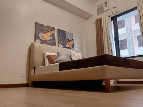 a couch in a living room with a window at Casa Josefina in Manila