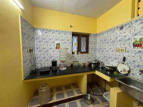 a kitchen with a sink and a counter top at Hostel Madras in Chennai