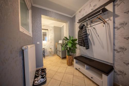 a hallway with a walk in closet and a pair of shoes at Aurora#1 mit großem Garten, Sauna und Kamin in Wiesmoor