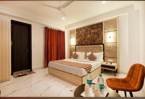 a bedroom with a bed and a table and a chair at HOTEL SHYAM INTERNATIONAL - NEAR TERMINAL 3 DELHI AIRPORT WITH - Free AIRPORT PICKUP in New Delhi