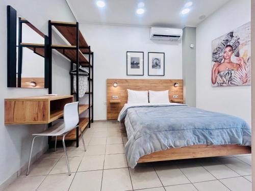 a bedroom with a bed and a desk and a ladder at Ithaca: Διαμέρισμα με αυτόνομη είσοδο. in Thessaloniki