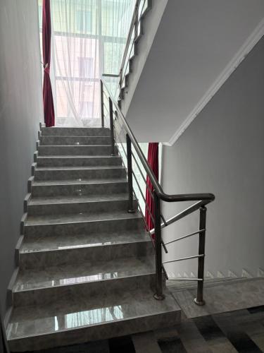 a staircase in a building with a stair railing at Гостиница Райхан in Atyraū