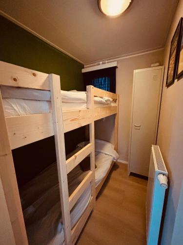 a bunk bed room with two bunk beds in it at Nature Escape Veluwe Chalet in Putten