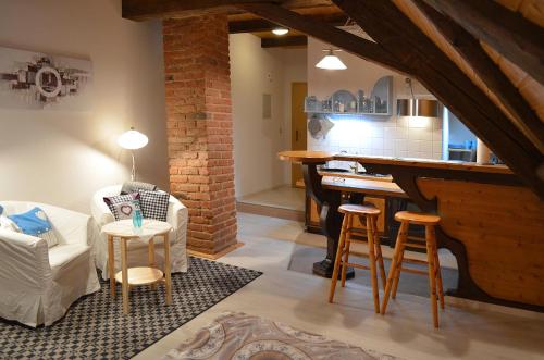 a living room with a bar and a kitchen at Ferienwohnungen Sternenthal in Menzenschwand