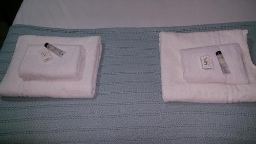 a bed with two towels and a toothbrush on it at The Oxford House in Oxford
