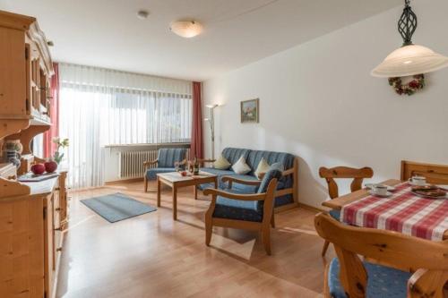 a living room with a couch and a table at Chiemgau Comfort F1 Ferienwohnanlage Oberaudorf mit Hallenbad und Sauna in Oberaudorf