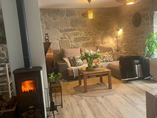 a living room with a fireplace and a couch at Casita puerto maritimo in Villanueva de Arosa