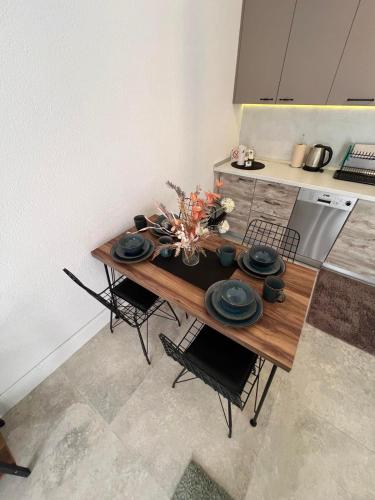 a kitchen with a wooden table with black dishes on it at Casa del Sole Lux in Kotor