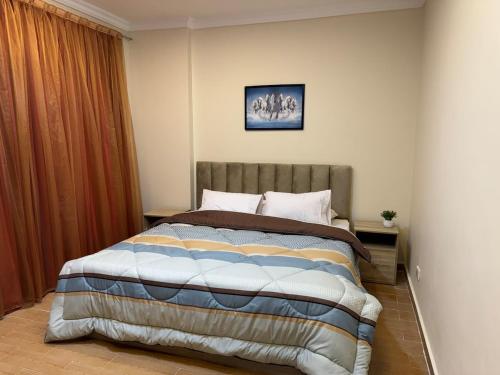 a bedroom with a bed in a room at Chic Modern Apartment - New Cairo in New cairo
