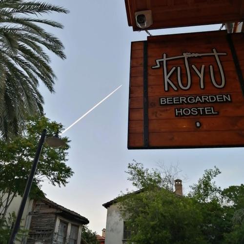a sign for a kiwi beer garden hospital at Kuyu Beergarden Hostel in Antalya