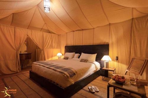 a bedroom with a bed in a tent at Asafar Luxury Camp in Merdani