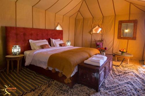 a bedroom with a large bed in a tent at Asafar Luxury Camp in Merdani