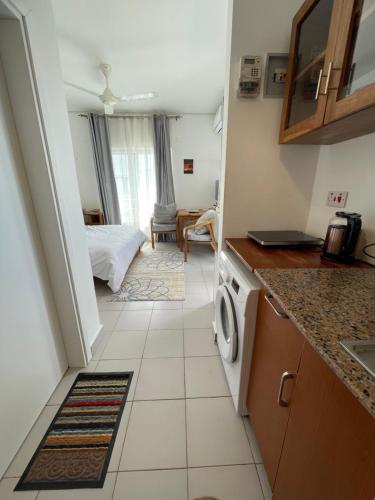 a small kitchen with a bed in a room at Fumba Town Tausi Apartments in Zanzibar City